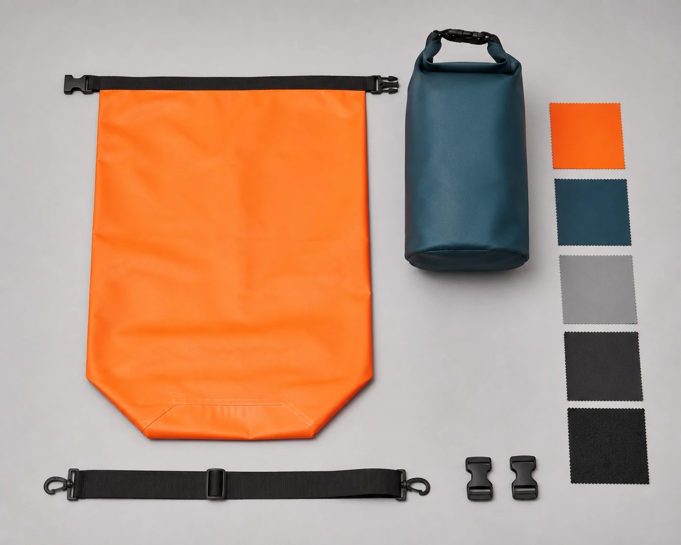 Complete flat orange bag and upright dark teal bag beside a detached strap, buckle pairs and five plain material swatches