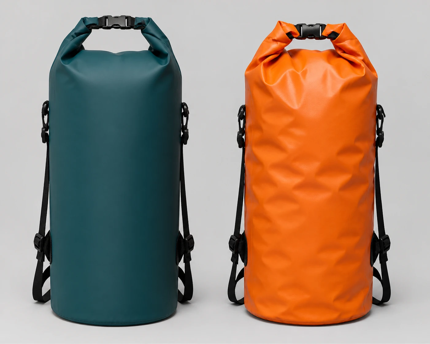Complete smooth dark teal roll-top bag and creased orange roll-top bag shown together with matching shoulder straps