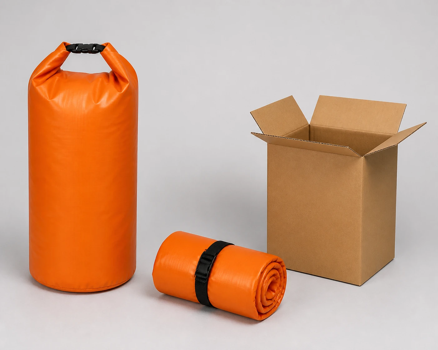 Complete upright orange roll-top bag beside the same bag rolled into a compact pack and one open plain kraft carton