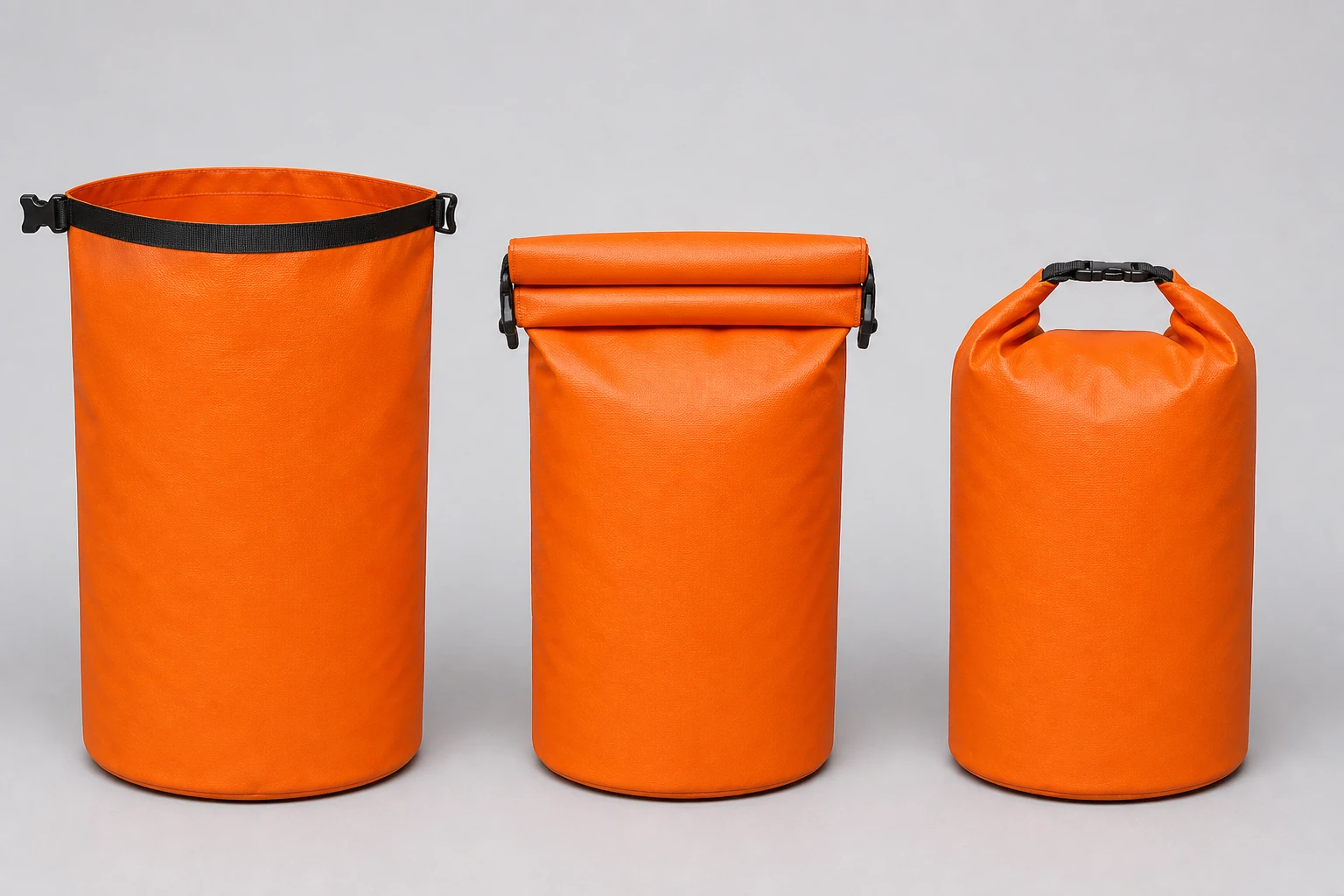 Three complete orange cylindrical bags showing an open mouth, a partially rolled collar and a fully rolled buckled closure
