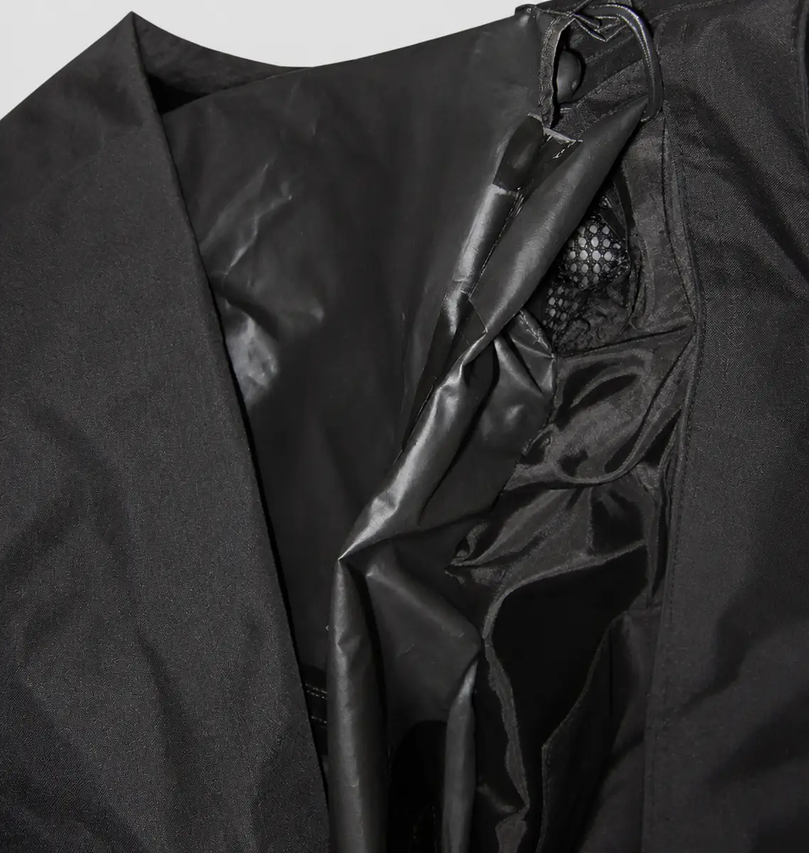 Unbranded black nylon hood and collar construction with drawcord and mesh ventilation detail