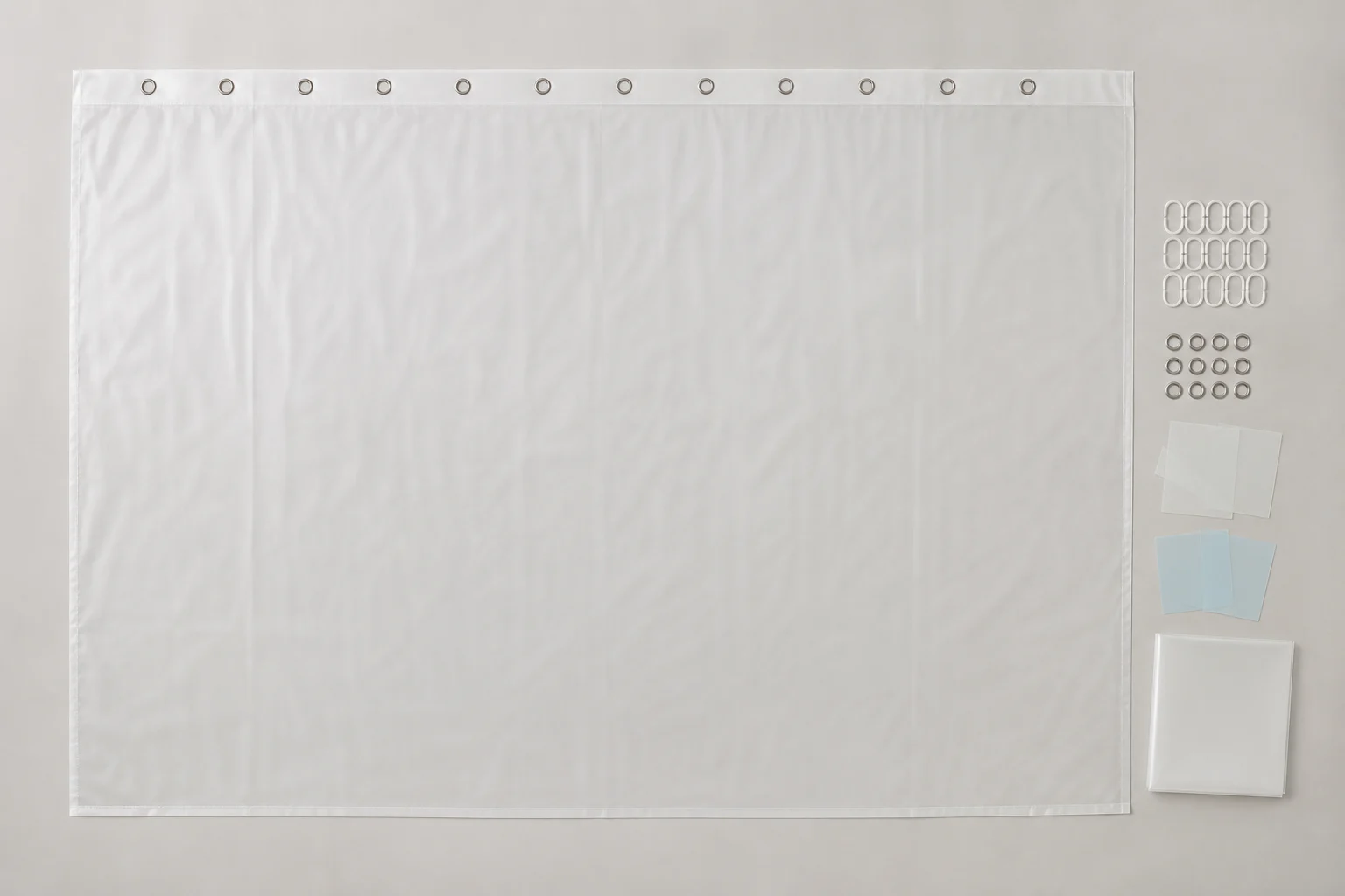Complete curtain, top-only grommets, hooks, swatches and blank pack arranged for sample release.