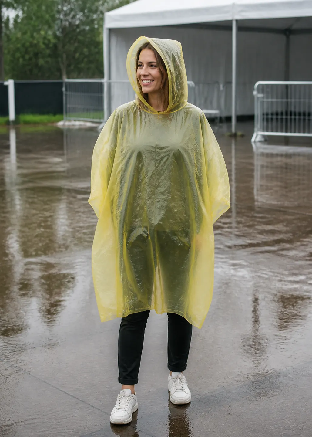 Adult event attendee wearing an unbranded yellow PE disposable cape poncho